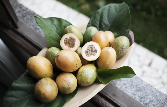 A bowl full of cherimoya resting on a ledge. Like a pie sitting in the window of your grandparents house