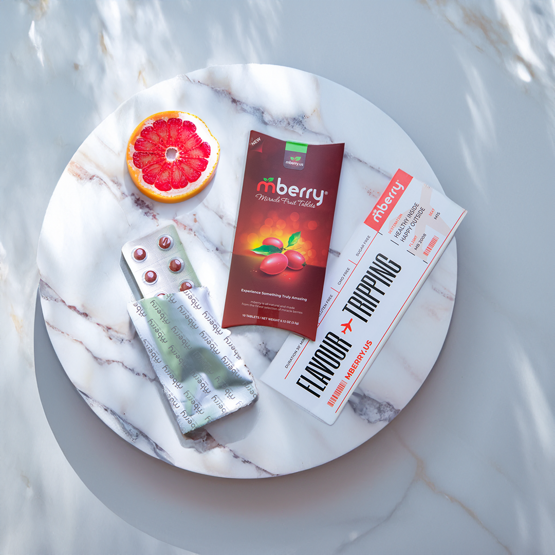 mberry miracle fruit tablets on marble table with flavor tripping flyer