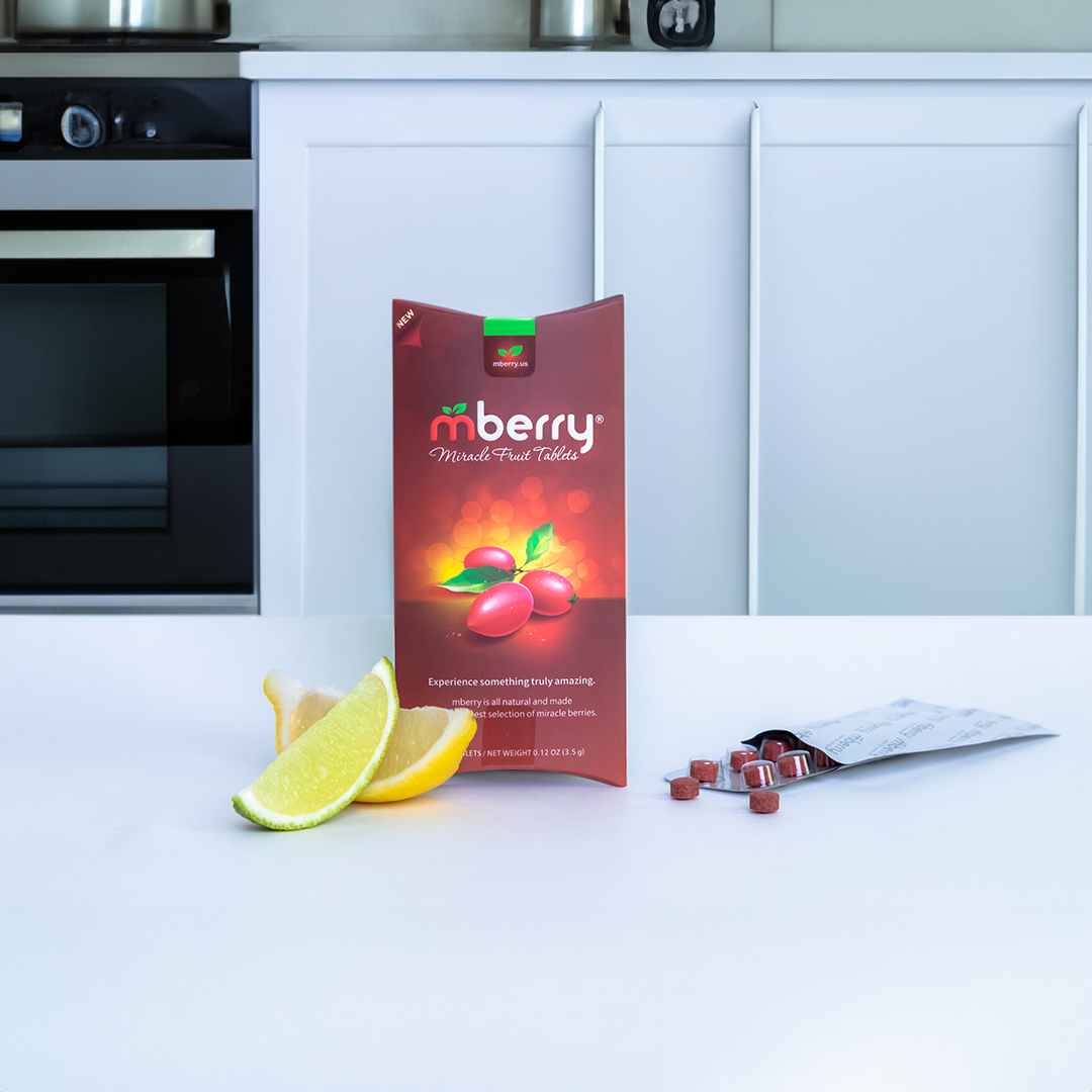 mberry Miracle Fruit Tablets in kitchen with tablets to the right and a lemon and lime to the left