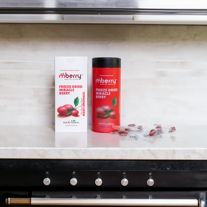 mberry Freeze Dried Miracle Berries on marble counter with marble tiles behind with individual berries to the right